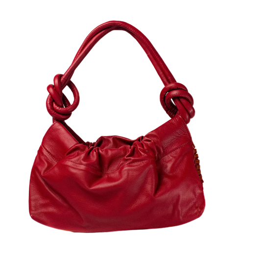 Red handbag with knotted handle on a white background